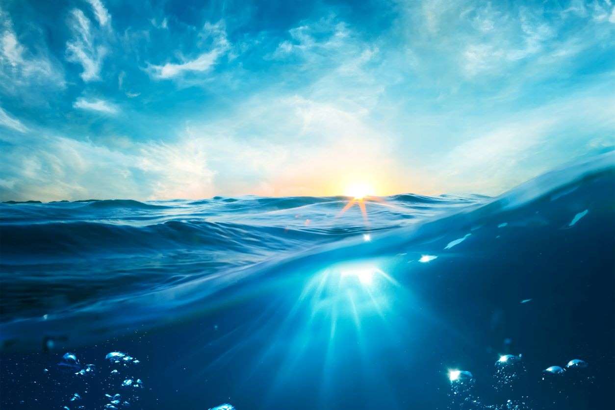 Big blue ocean with sun on the horizon