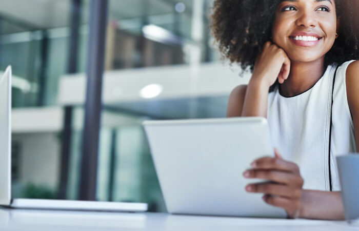 woman smiling while reviewing her Microsoft Power Platform projects