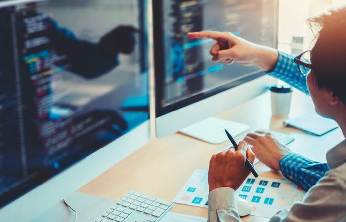 Person pointing at computer screen