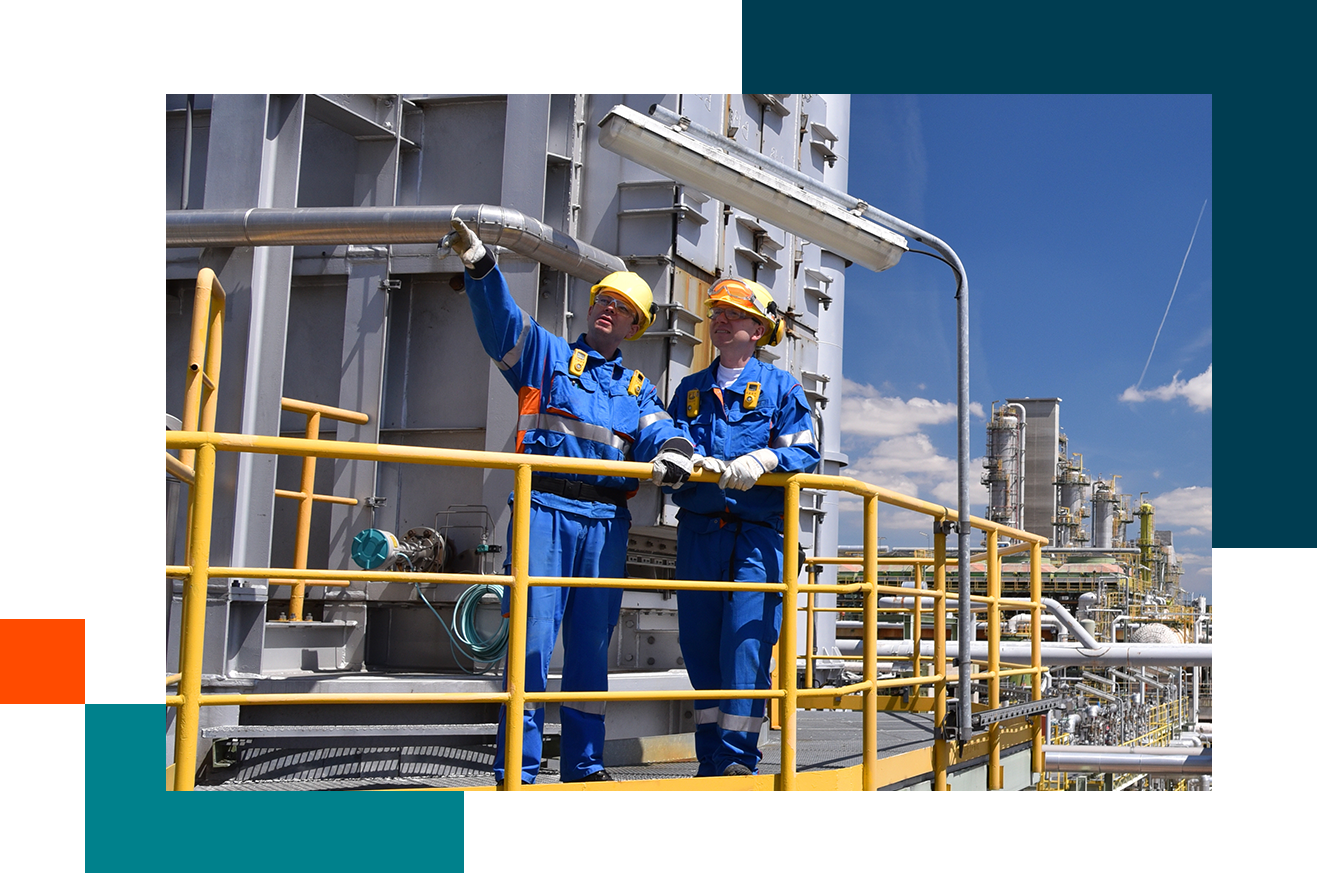 Two workers standing on pedway pointing into the distance