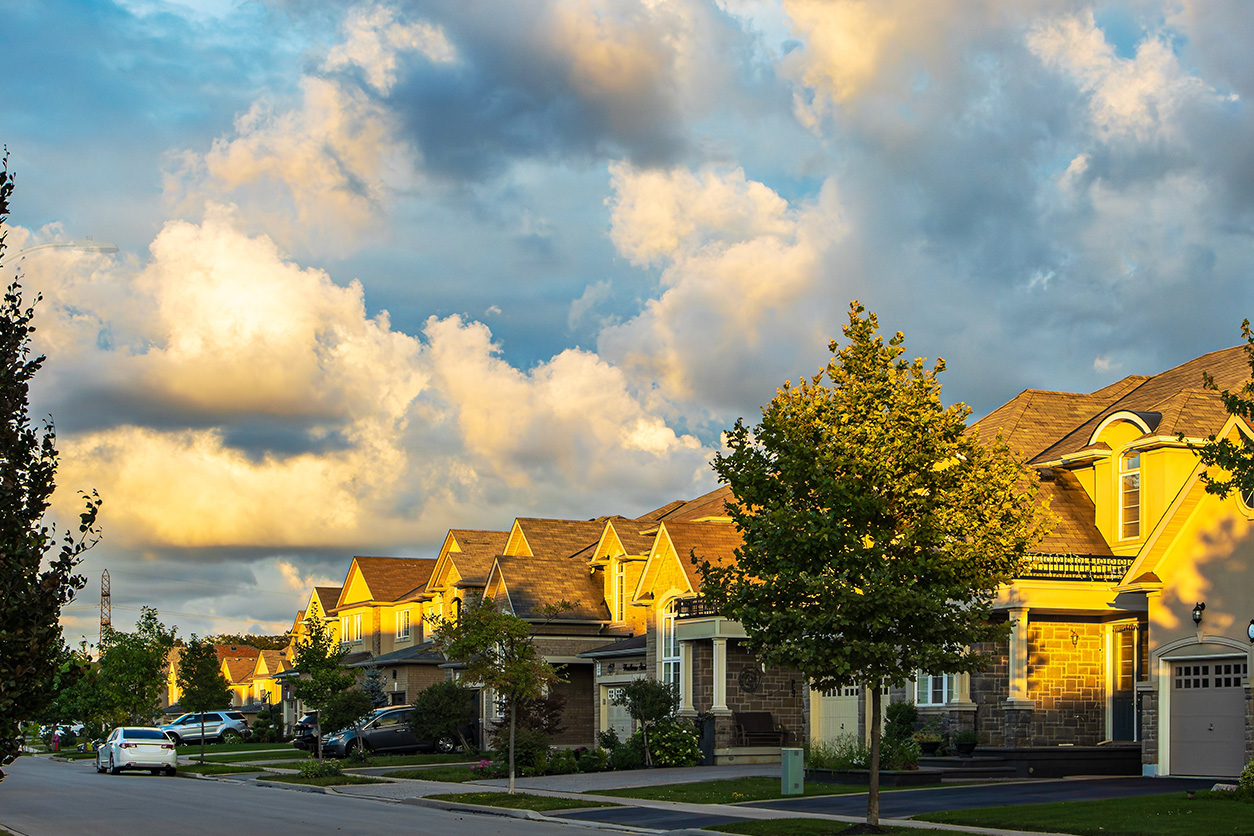 Suburban street with lots of clouds in the sky