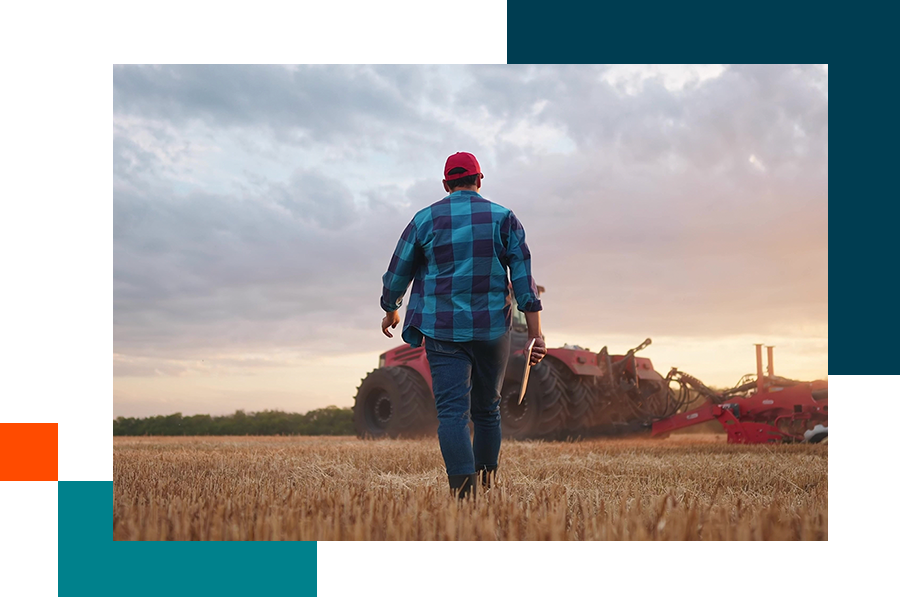 farmer with a tablet walking towards his tractor
