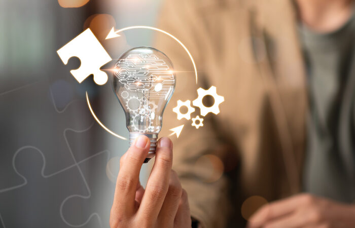 technology lightbulb circled by a puzzle piece and gears
