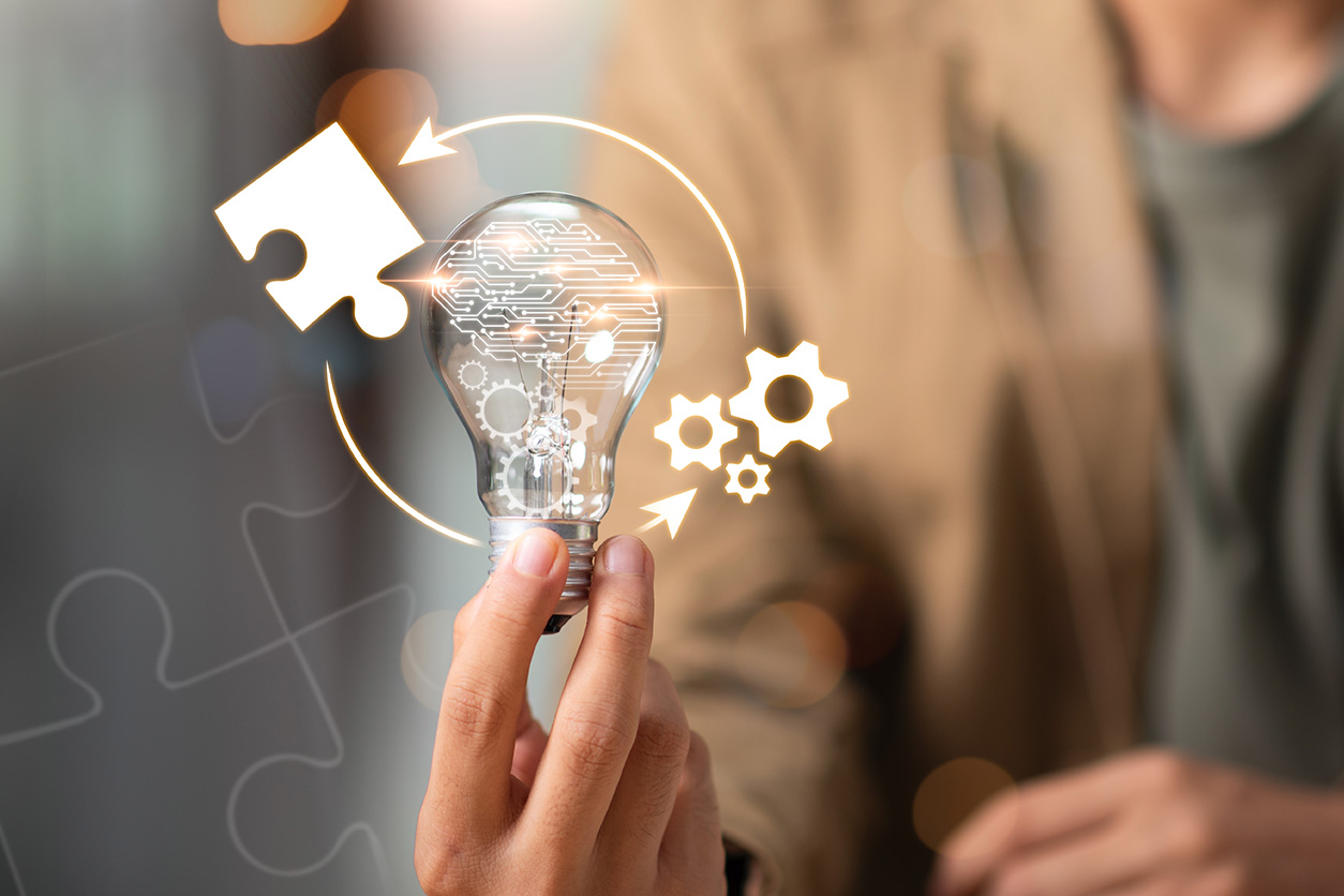 technology lightbulb circled by a puzzle piece and gears